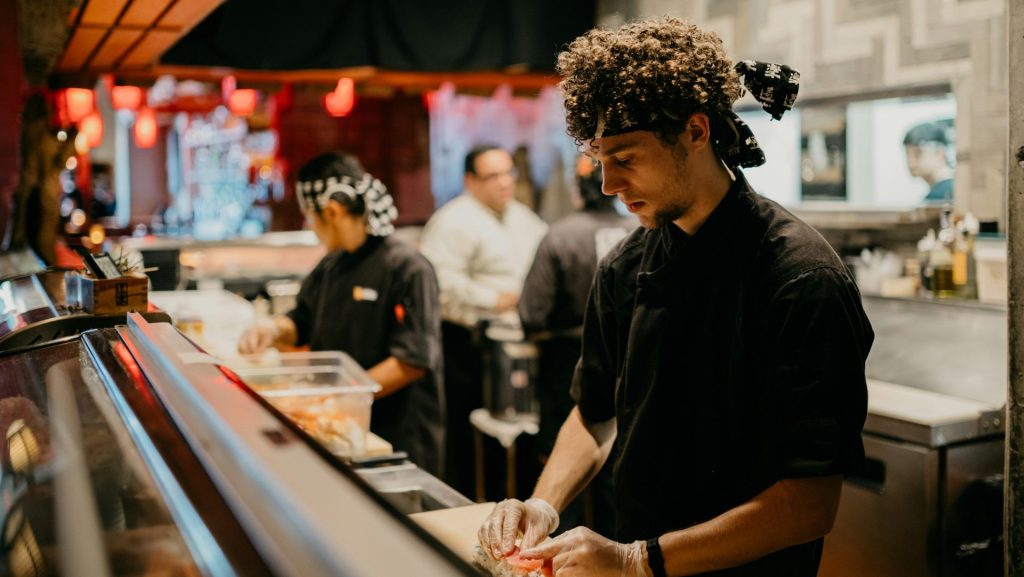 a group of people in a kitchen